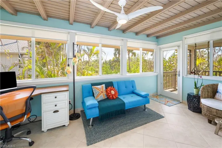 Sunroom / solarium featuring ceiling fan, a healthy amount of sunlight, wood ceiling, and beamed ceiling