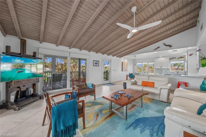 Living room featuring french doors, light tile patterned floors, wooden ceiling, high vaulted ceiling, and ceiling fan
