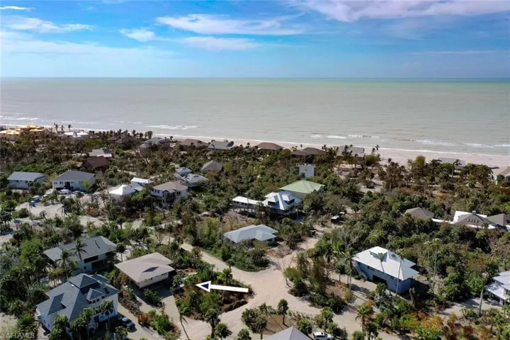 Aerial view featuring a water view and a view of the beach