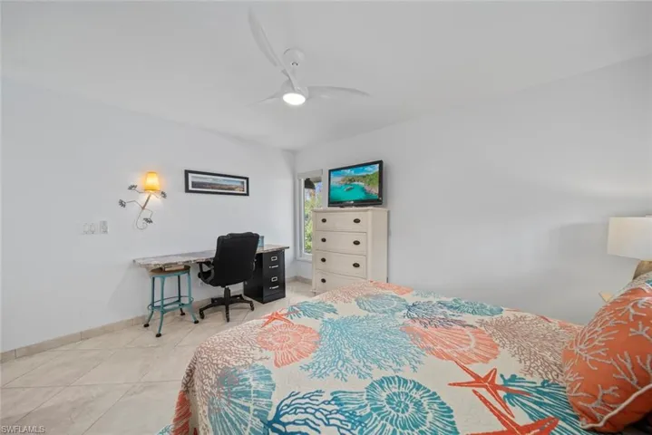 Tiled bedroom with ceiling fan