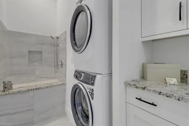 Laundry area with estacked washer and dryer