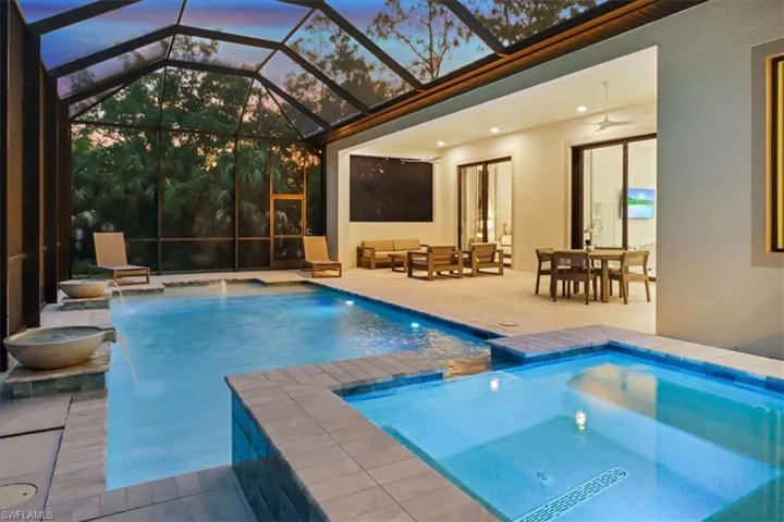 View of swimming pool with a patio area, a ceiling fan, an outdoor living space, and a pool with connected hot tub