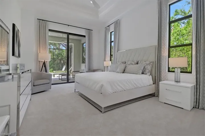 Owner's bedroom with 12' ceilings (13' in the coffers), 10' sliding glass door to covered lanai