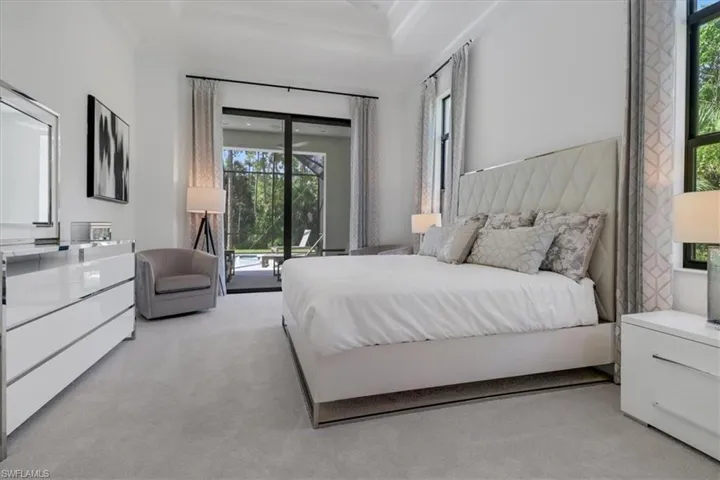 Owner's bedroom with 12' ceilings (13' in the coffers), 10' sliding glass door to covered lanai