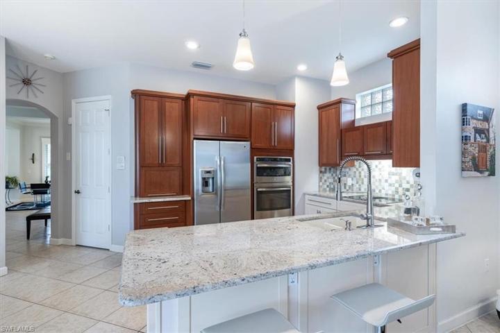 Wood cabinetry with “Appliance Garage”, stainless steel appliances