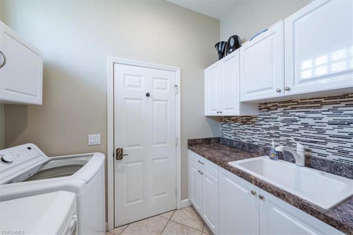 Laundry room with large sink and access to garage