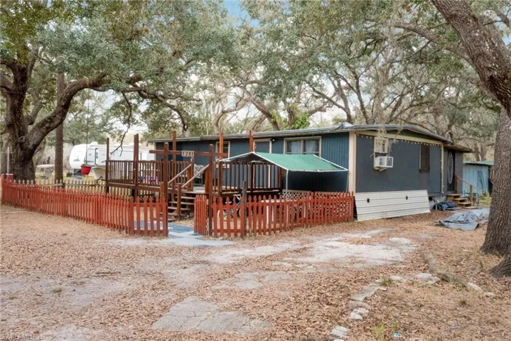 View of front of home featuring a deck and cooling unit