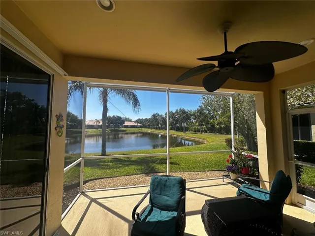 Sunroom / solarium featuring a water view and ceiling fan