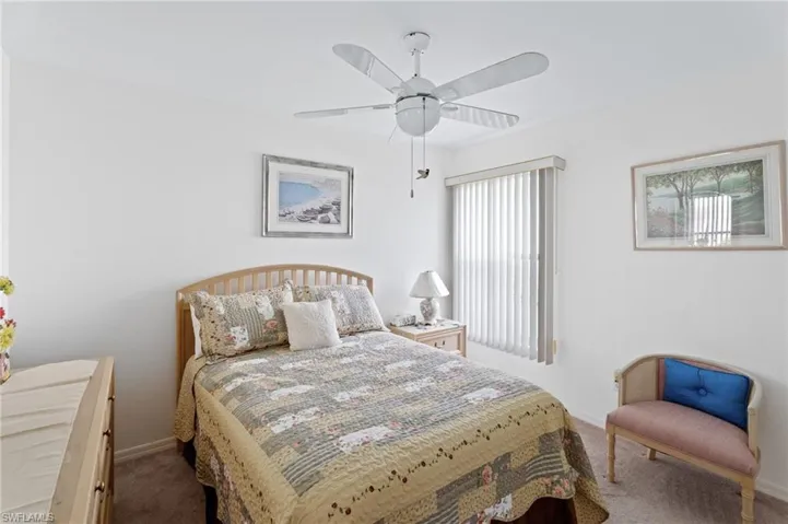 Carpeted bedroom with baseboards and ceiling fan