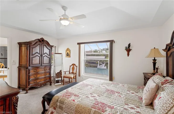 Carpeted bedroom featuring ceiling fan