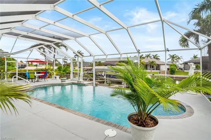 Outdoor pool with a patio area and a lanai