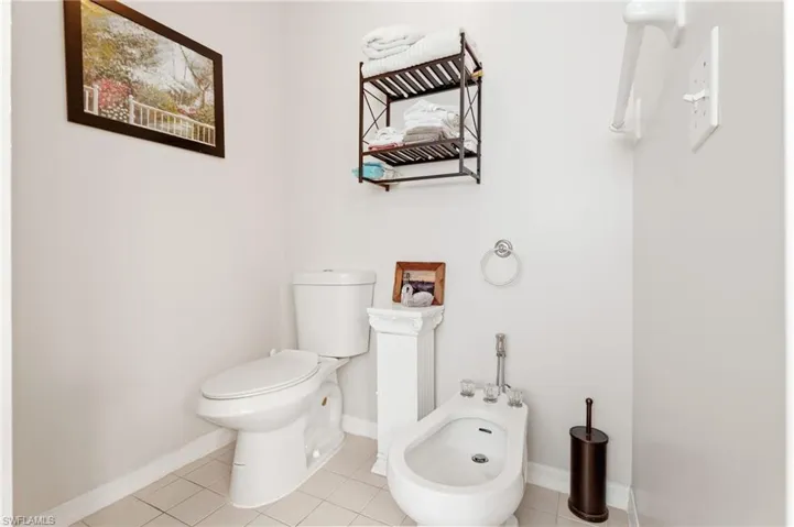 Bathroom featuring a bidet and tile patterned floors