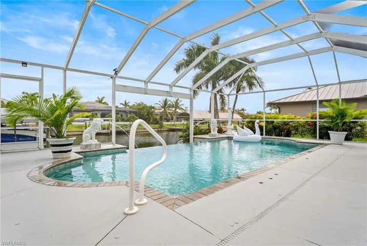 Outdoor pool with a patio area, a lanai, and a water view