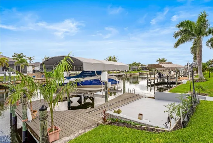 Dock area featuring boat lift and a water view