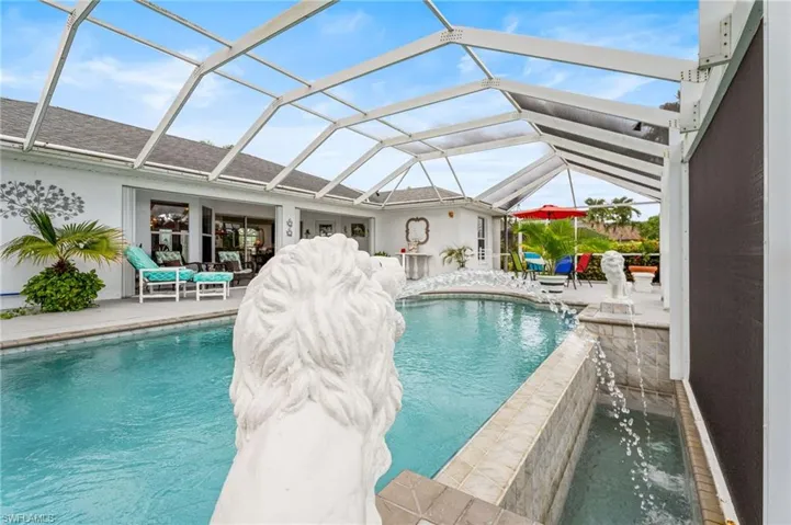 Swimming pool with a patio and glass enclosure
