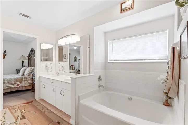 Ensuite bathroom with a garden tub and vanity