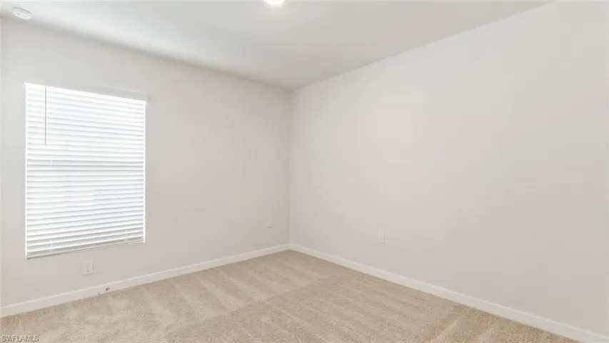 Model home. Carpeted empty room with baseboards