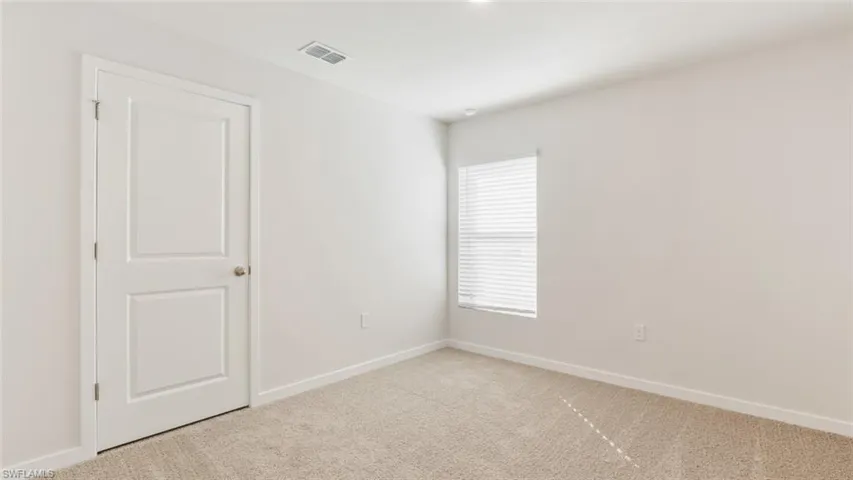 Model home. Carpeted spare room featuring baseboards