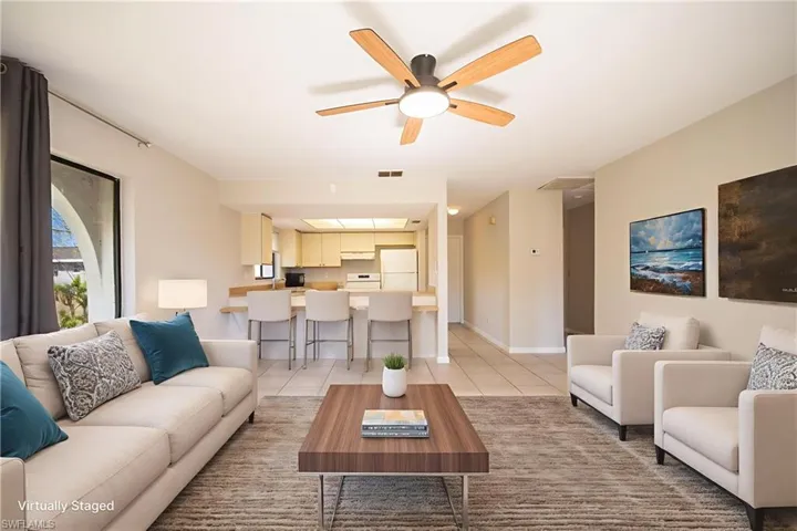 Living room featuring ceiling fan and light tile patterned floors