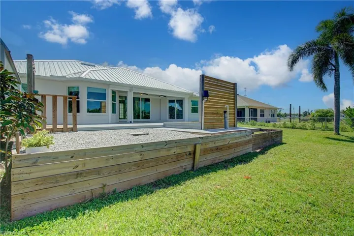 Back of house featuring a metal roof