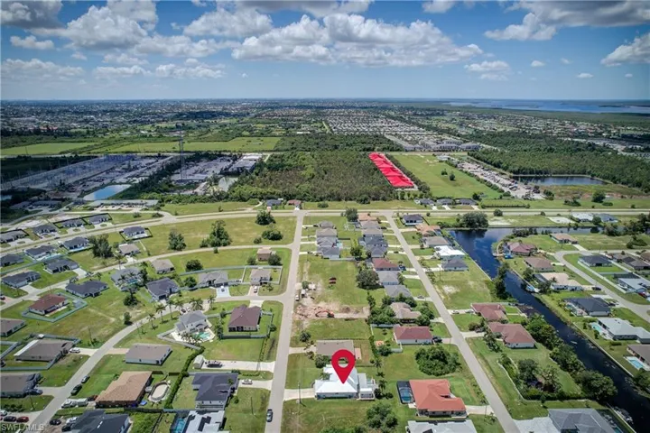 View of property location with a large body of water and nearby suburban area