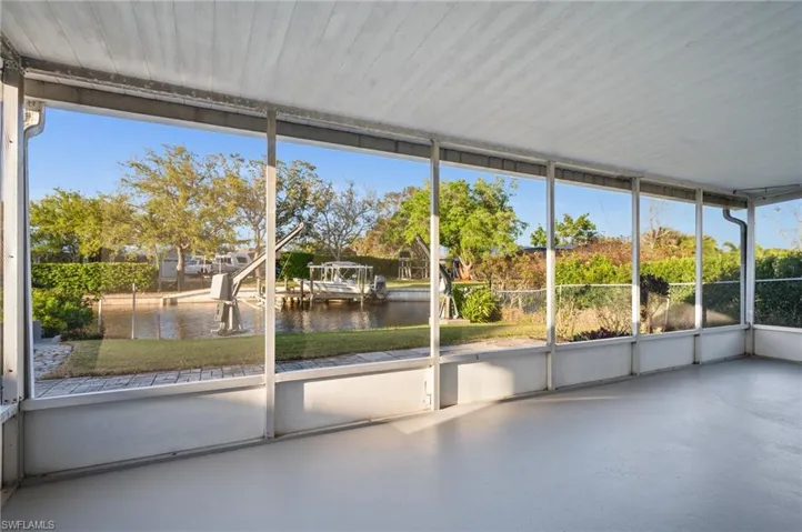Unfurnished sunroom featuring a water view