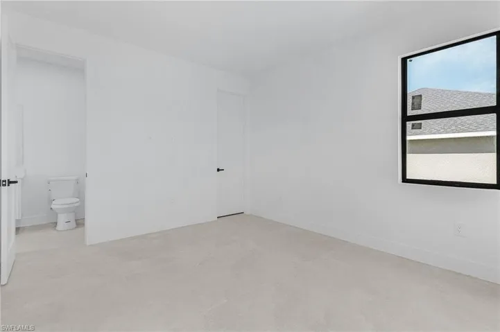 Unfurnished room with baseboards