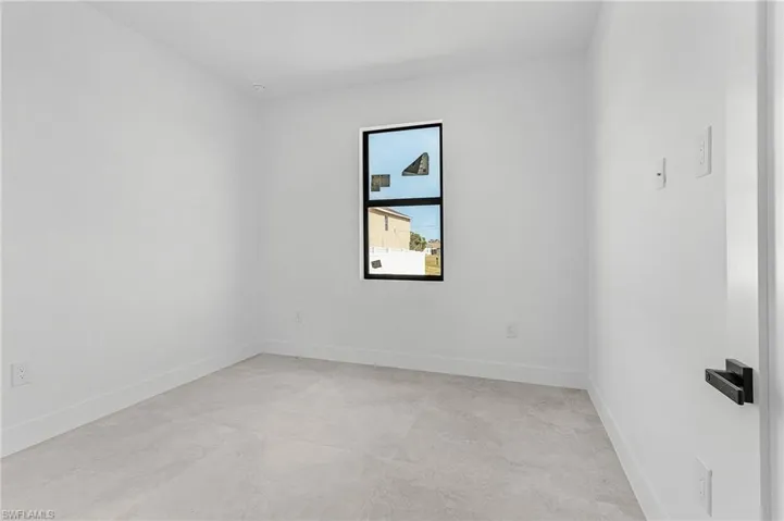 Unfurnished room featuring concrete floors and baseboards