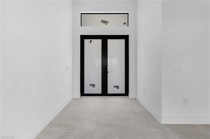 Spare room featuring concrete floors and baseboards
