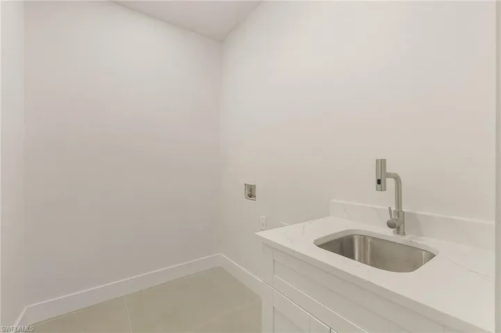 Bathroom with sink and tile patterned flooring
