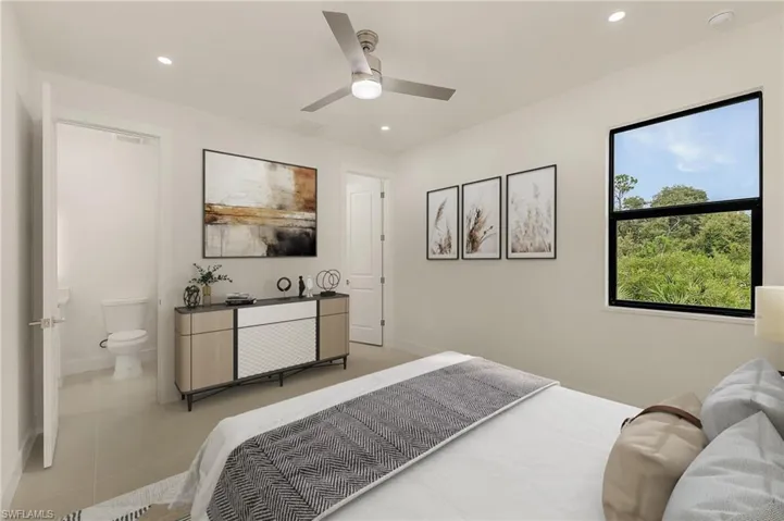 Tiled bedroom featuring ensuite bath and ceiling fan