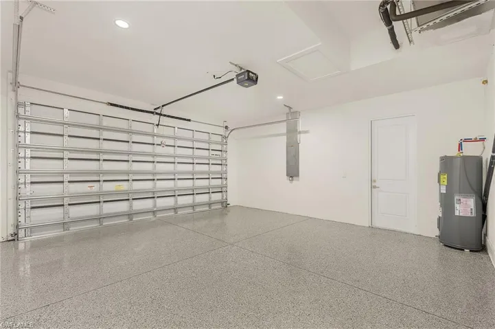 Garage with electric water heater and a garage door opener
