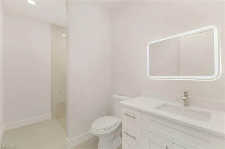 Bathroom with vanity, tile patterned flooring, and toilet