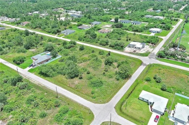 Aerial view of property's location featuring nearby suburban area