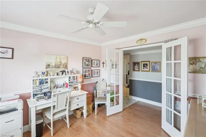 Office featuring ornamental molding, french doors, ceiling fan, and light hardwood / wood-style flooring