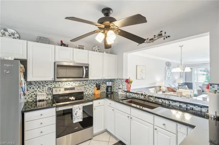 Kitchen featuring white cabinetry, appliances with stainless steel finishes, and sink