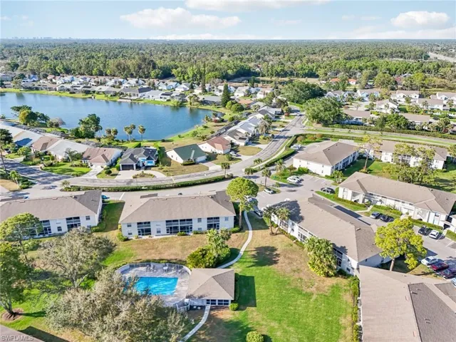 Birds eye view of property with a water view
