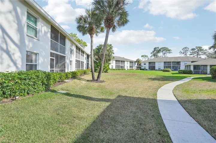 View of property's community featuring a yard
