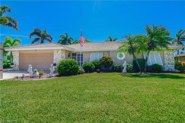 Single story home with a front lawn and a garage