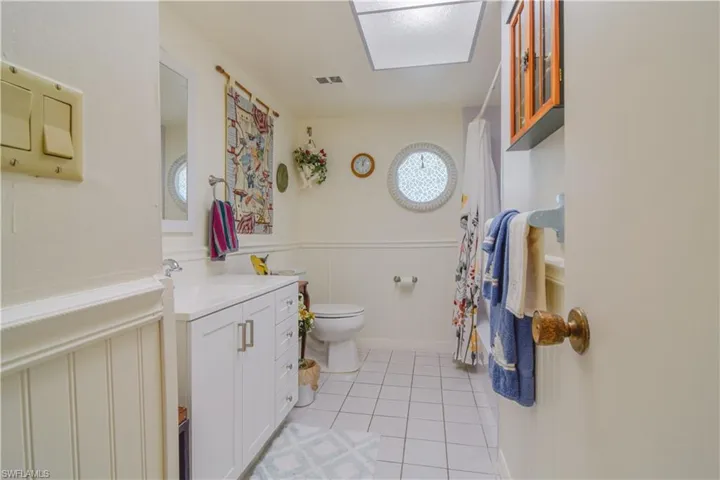 Bathroom with vanity, toilet, and tile floors