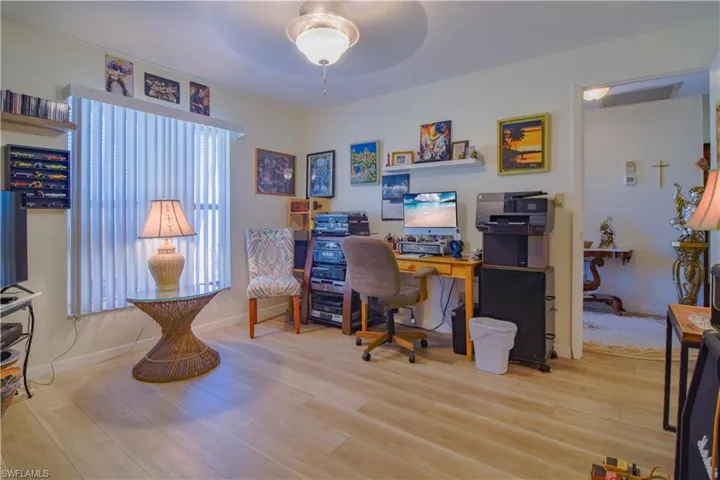 Home office featuring light wood-type flooring and ceiling fan