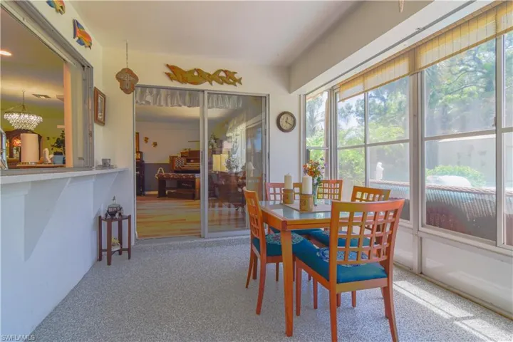 Carpeted dining space with a wealth of natural light