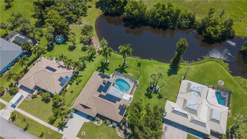Birds eye view of property with a water view