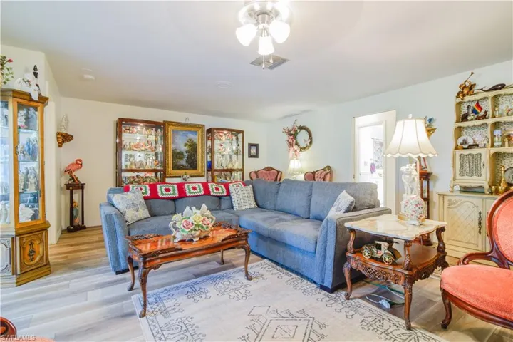 Living room with ceiling fan and light wood-type flooring