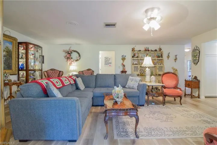 Living room with wood-type flooring and ceiling fan