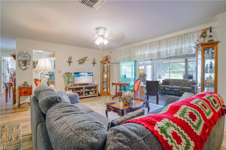 Living room featuring hardwood / wood-style flooring and ceiling fan