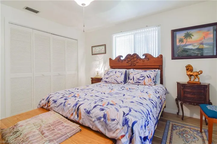 Bedroom with a closet, ceiling fan, and hardwood / wood-style floors