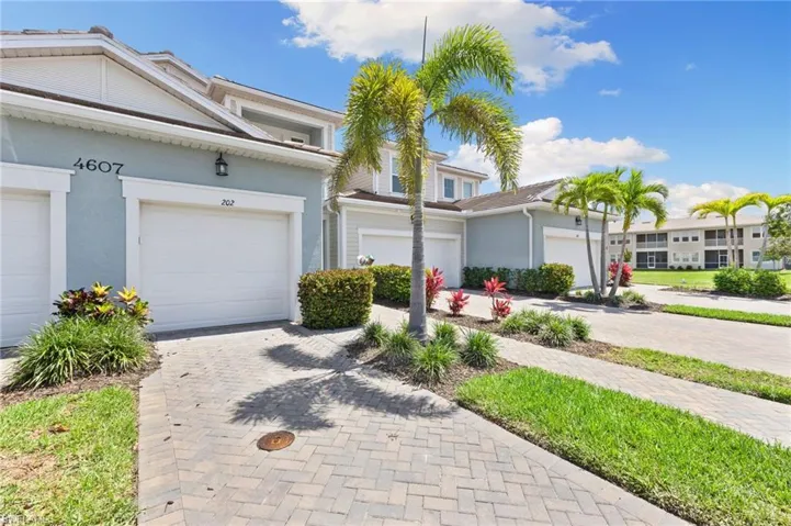 View of front of home featuring stucco siding and decorative driveway
