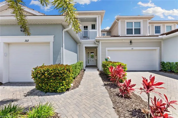 View of front of house featuring driveway and stucco siding