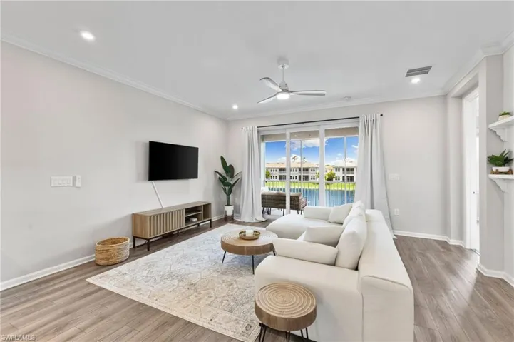 Living area featuring crown molding, light wood finished floors, a ceiling fan, and recessed lighting